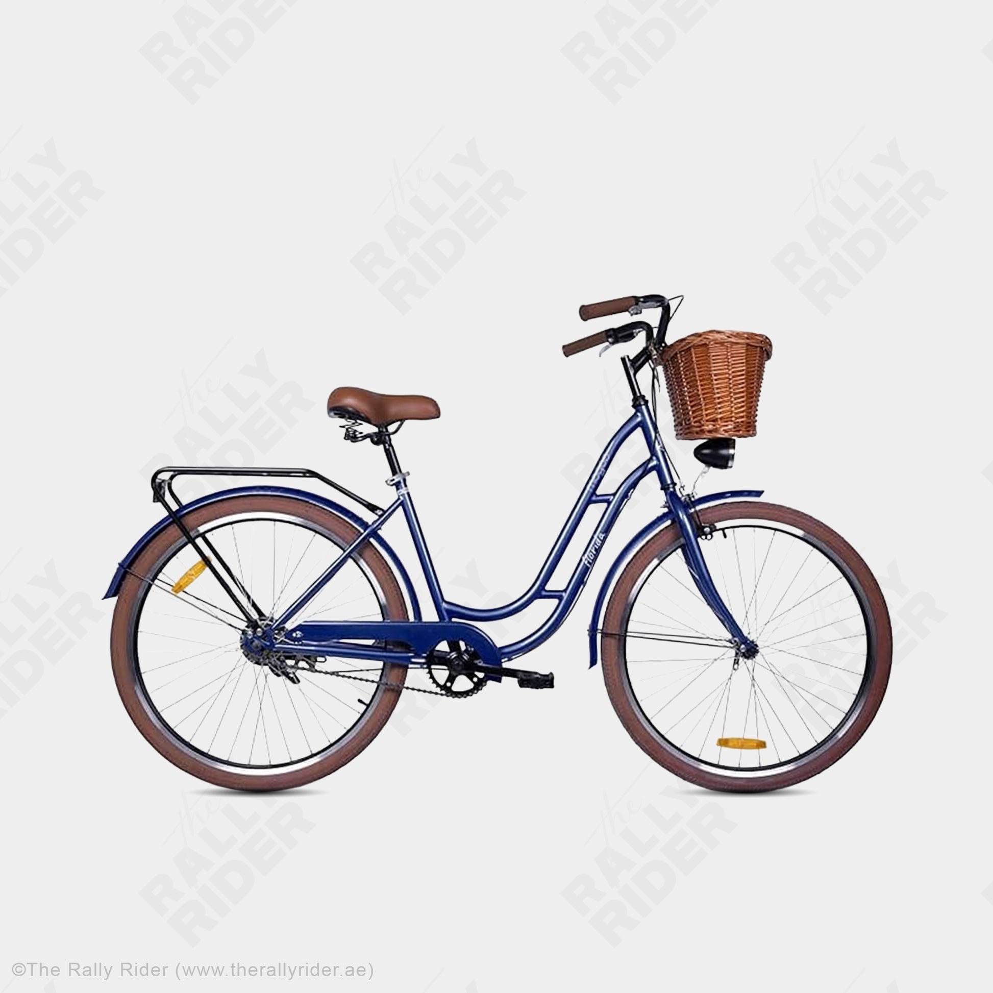 Mogoo Florida single speed city bike in dark blue with front wicker basket, rear carrier, and brown-wall tyres